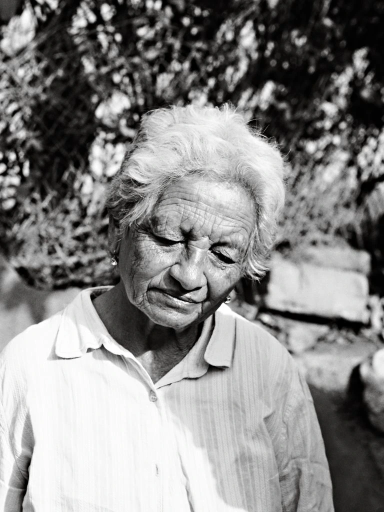 Liliana Gonin at the workbench, holding a small brass ring.